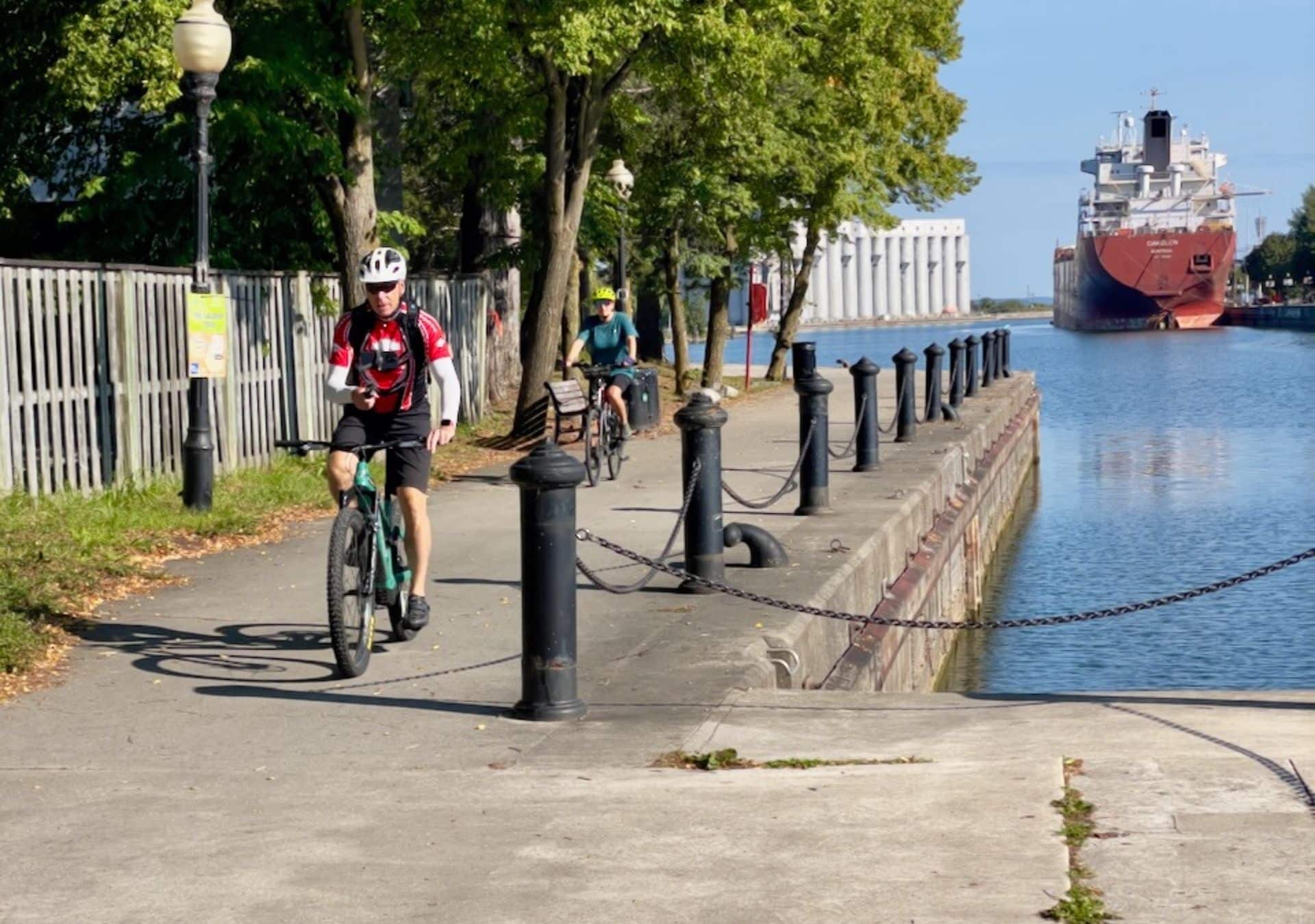 Bicyclists along a waterfront path.