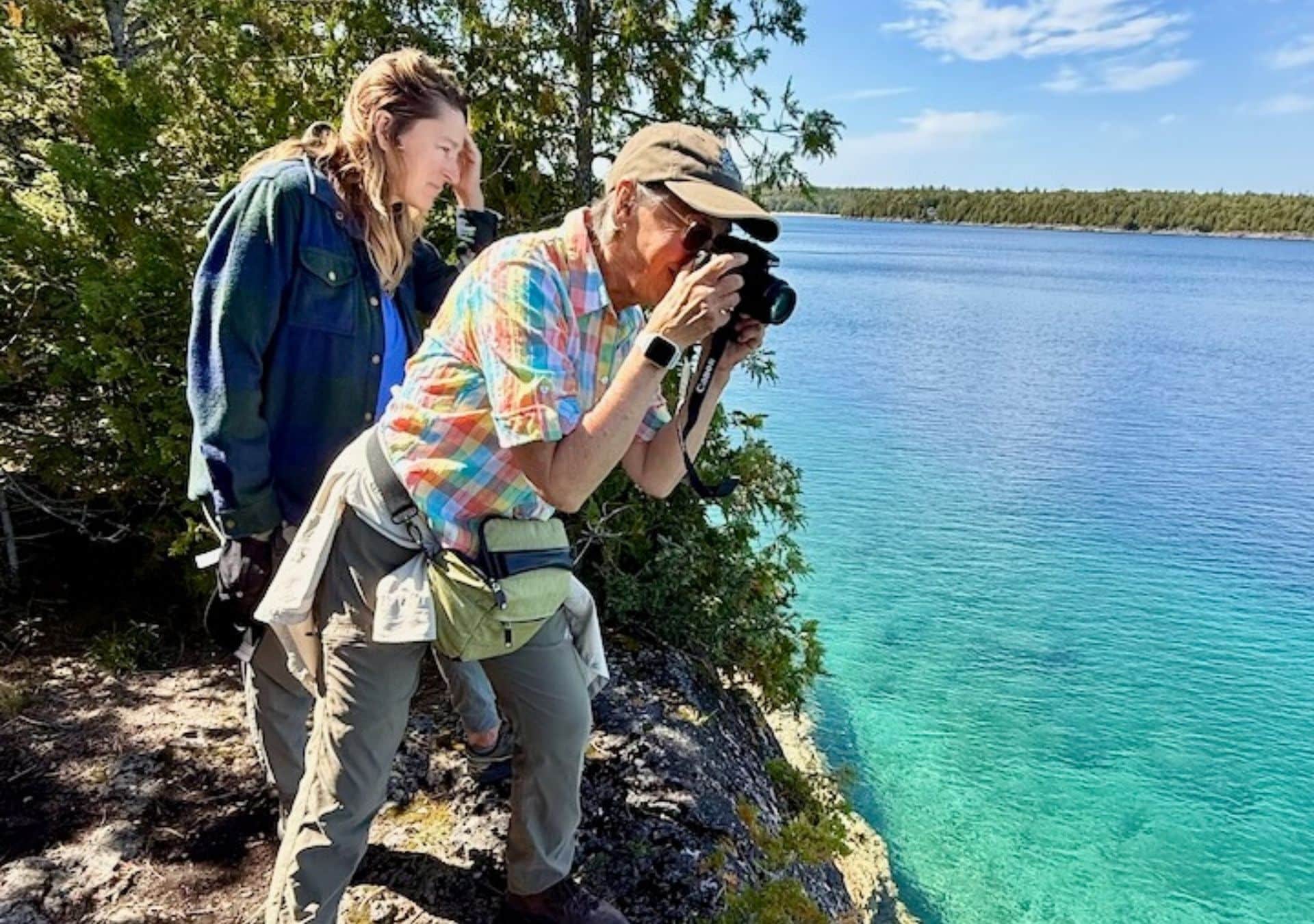 Photographers by a scenic lake.