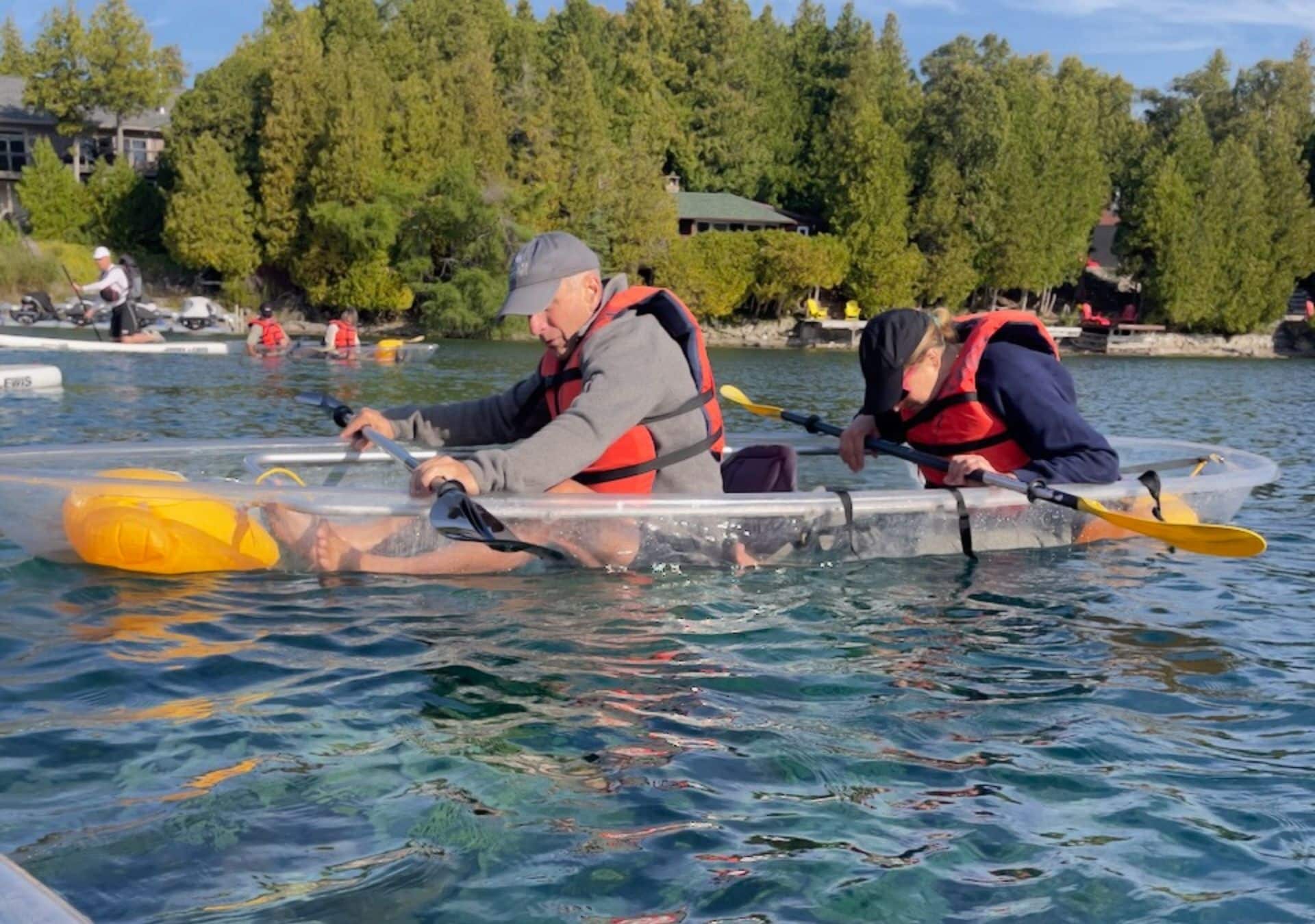Two people kayaking on water.