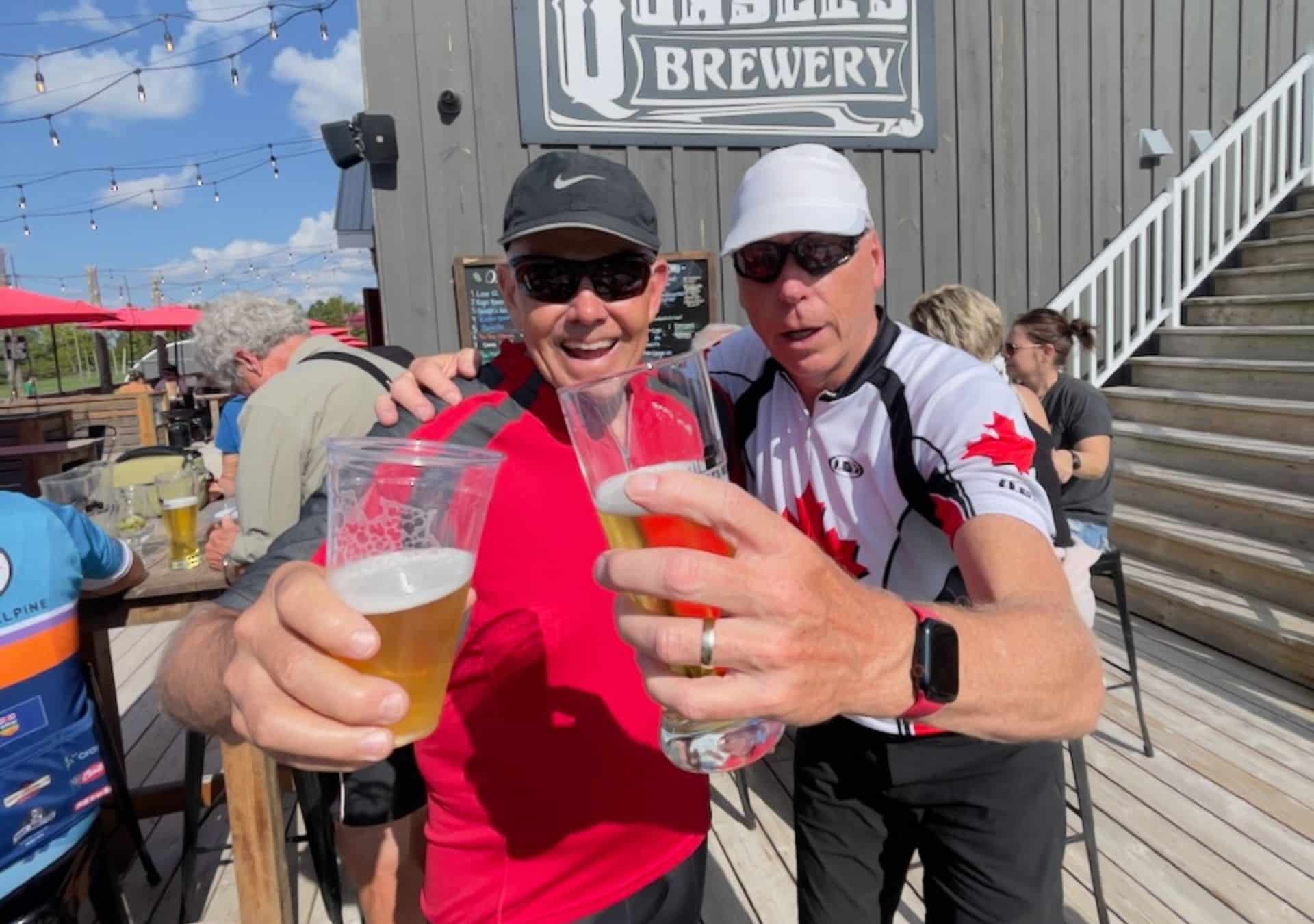 Two people toasting with beers.