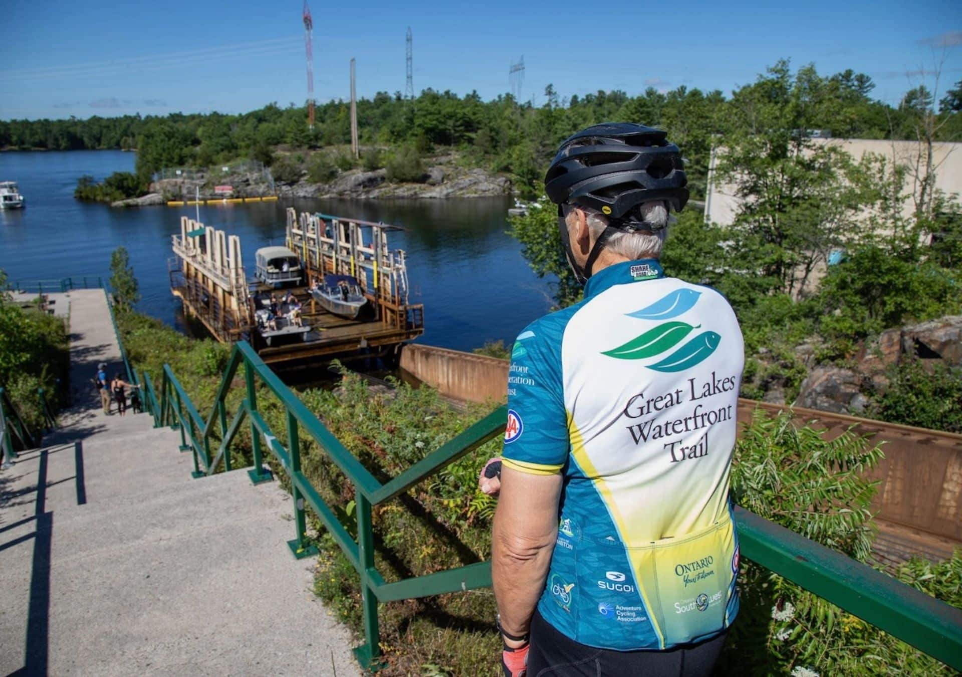 Cyclist overlooking waterfront and ferry.