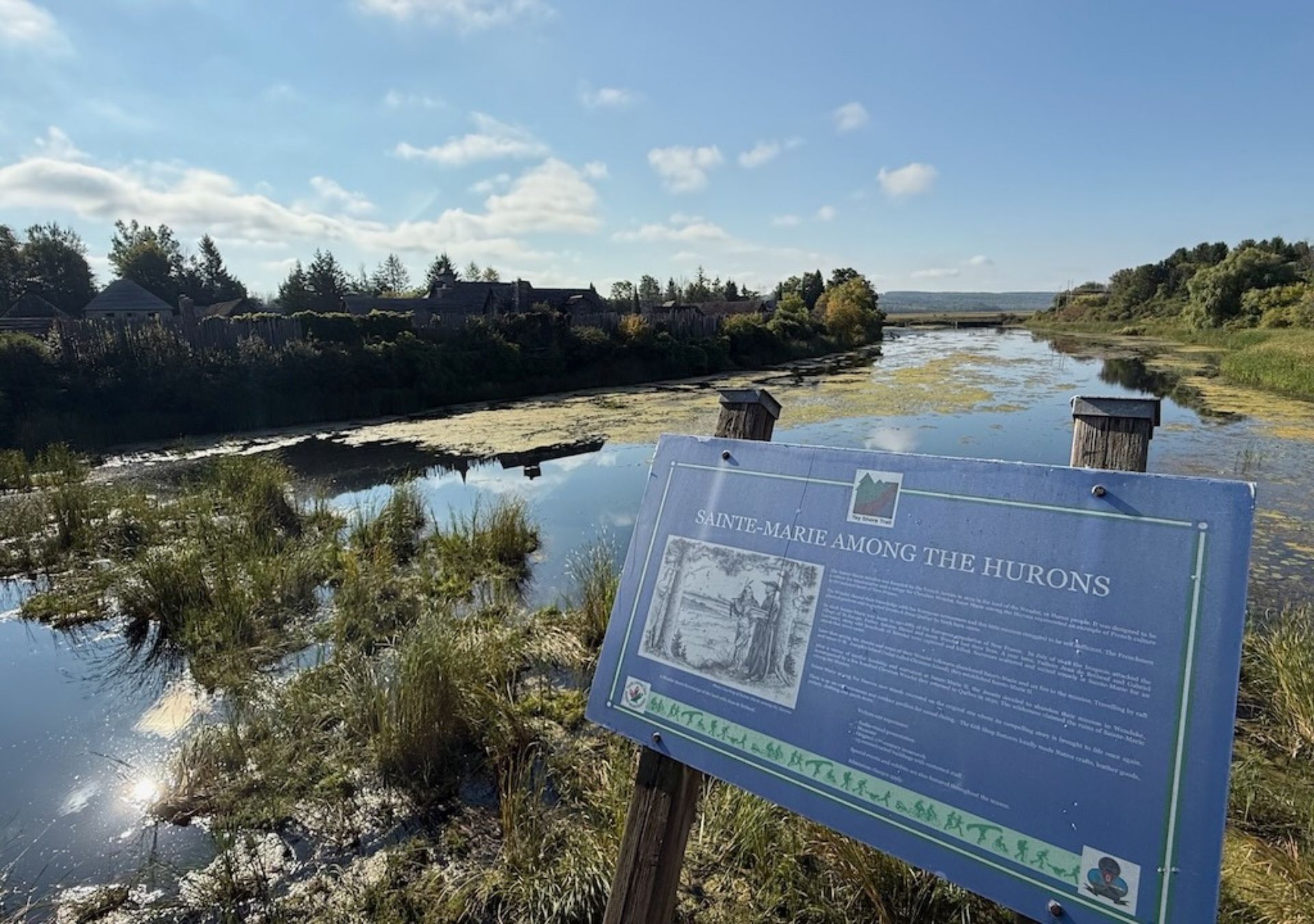 Scenic river view with historical sign