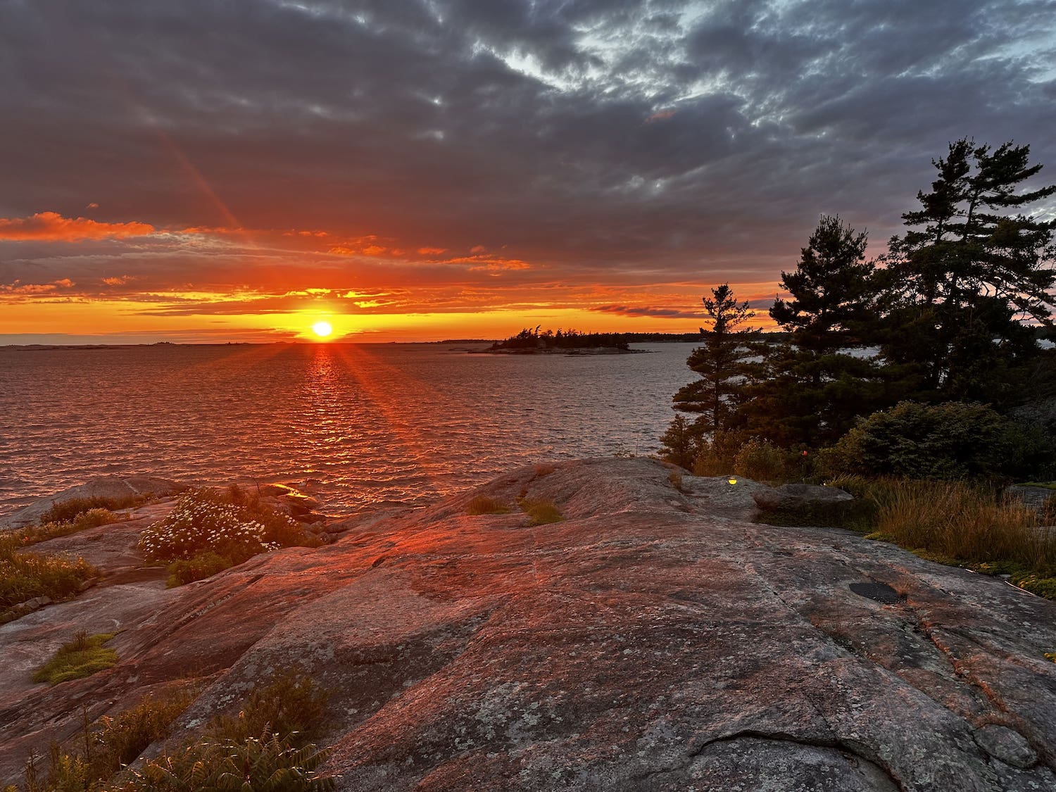 Sunset over rocky shoreline and water
