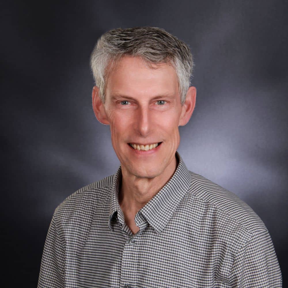 Person in checkered shirt, neutral background