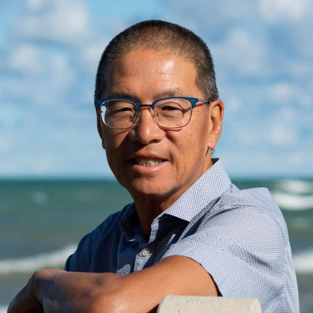 Man sitting by the ocean.